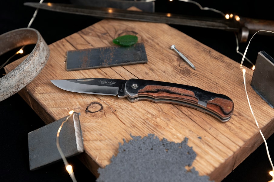 Folding knife on a board with whetstones